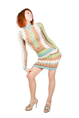 beauty redhead woman in fashion dress, hand on knee, isolated