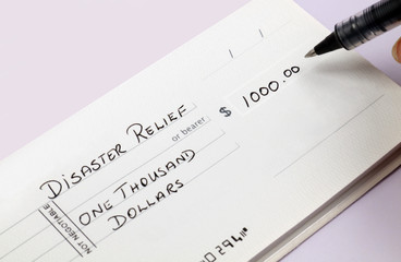 Disaster relief check being written for one thousand dollars.