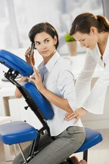 Businesswoman talking on phone during massage