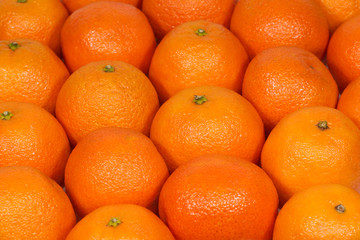 Many orange tangerines as background