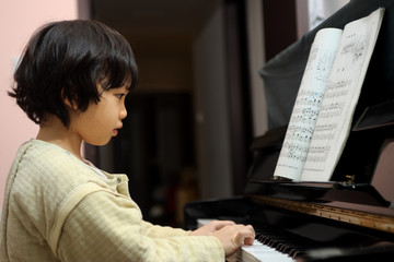 Asian kid playing piano