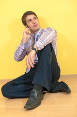 Attractive young business man sitting and enjoying a conversatio