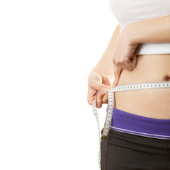 Woman measuring waistline with a tape isolated on white backgrou