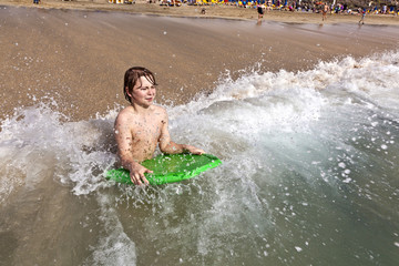 boy has fun in the waves