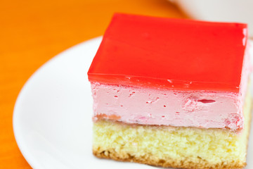 cake at the plate lying on an orange cloth