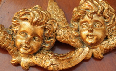 angelic faces carved in wood and gold painted