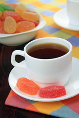 Cup of tea and fruit candy.