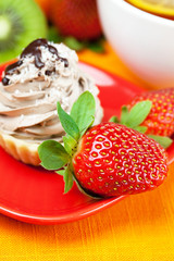 lemon tea ,lemon,mandarin.kiwi,cake and strawberries lying on th