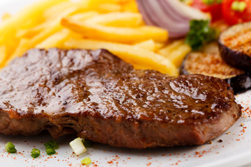 Steak with chips and vegetables