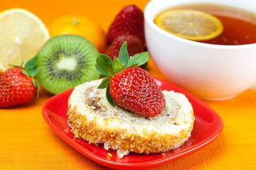 lemon,lemon tea,mandarin,kiwi,cake and strawberries lying on the