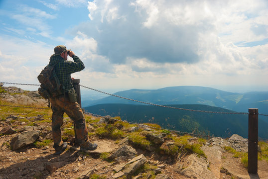 Hiker stands on a peak