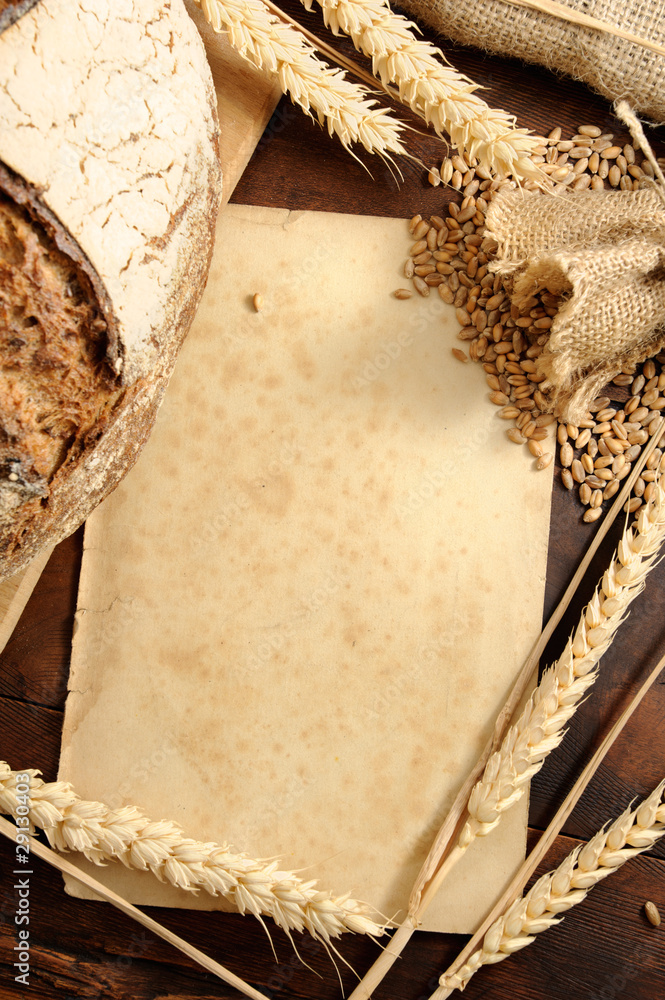 Wall mural Piece of old paper with wheat ears background. Shallow DOF