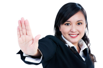 Happy young businesswoman indicating stop sign