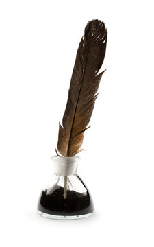 Feather and ink bottle isolated on white