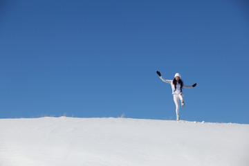 Naklejka na ściany i meble The jumping young girl on snow