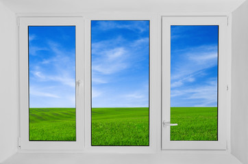 Plastic window with view to green field