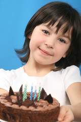Happy girl with birthday cake (studio shot)