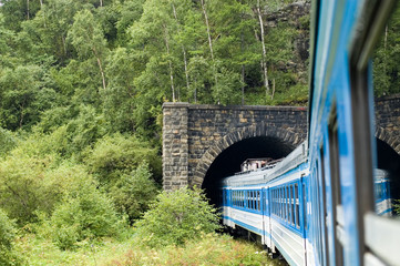 The train drives into a tunnel on Circum-Baikal railroad, Russia