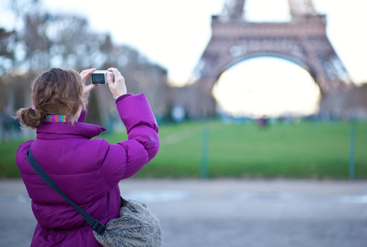 Tourist taking a picture of the Eiffel Tower