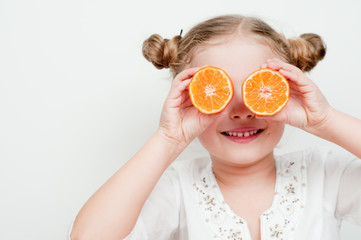 Little girl with fresh mandarin fruits