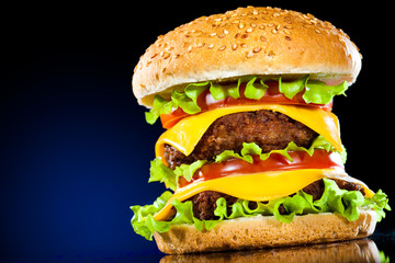 Tasty and appetizing hamburger on a dark blue