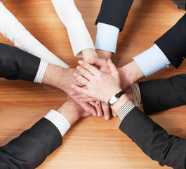 Workers hold hands together