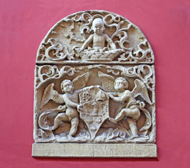 Stone emblem relief from ancient house facade. Krakow in Poland.