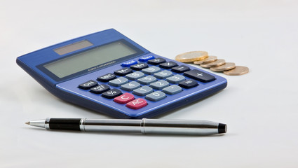 calculator, pen and coins on plain background