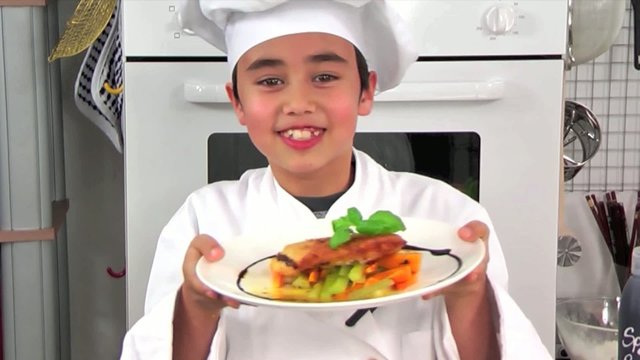 child presenting a dish from the menu