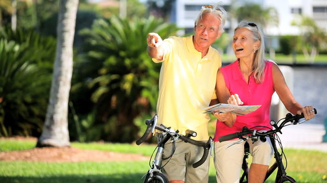 Retired Couple Using a Map on a Cycling trip