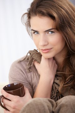 Attractive female drinking tea smiling