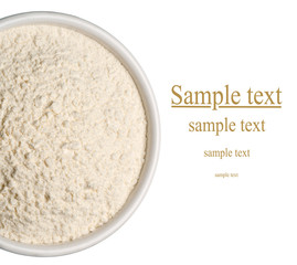 Wheat flour in a plate on white background