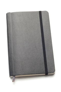 Black Moleskine Notebook On White Background