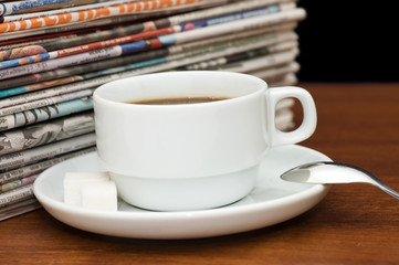 Cup from coffee and the newspaper