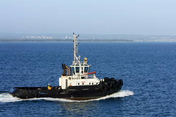 Tugboat under power at sea.