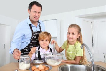 Father and children preparing pancakes