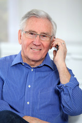 Elderly man talking on mobile phone