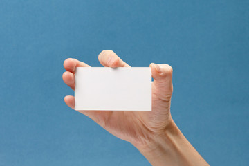 businessman's hand holding blank white paper business card
