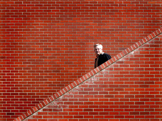 Man Walking down Stairs Brick Wall