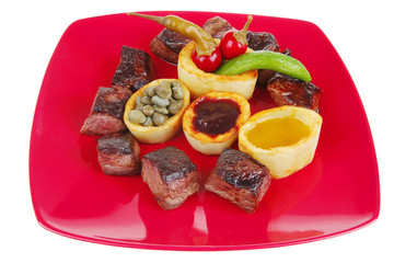 food: roast beef meat over red plate