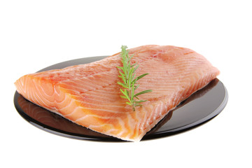 fresh raw salmon fillet on black with rosemary