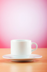 White cup against colourful gradient on the table