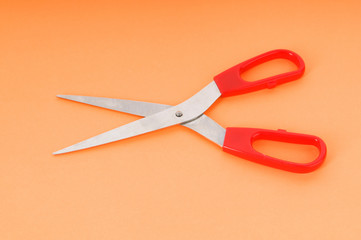 Colorful scissors on the color paper background