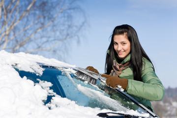 Winter car - woman remove snow from windshield