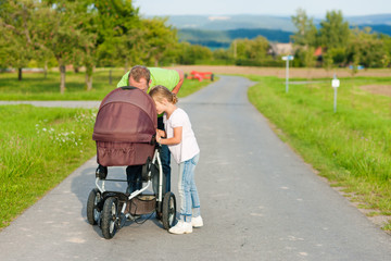Father with child and baby buggy