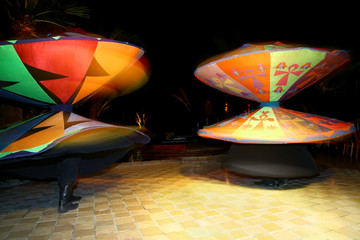 two man dancing tanura in bright skirts in Egypt at night street