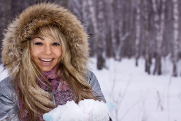 young pretty smiling woman in winter forest