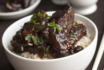 Mini spare pork ribs in a sticky hoisin sauce with rice