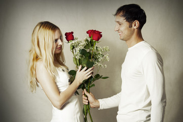 Young loving couple with flowers