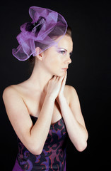 Beautiful young woman in a purple hat